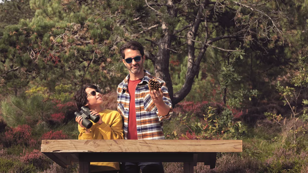 Boy and father looking at birds outdoors while wearing HOYA Sensity 2 sunglasses